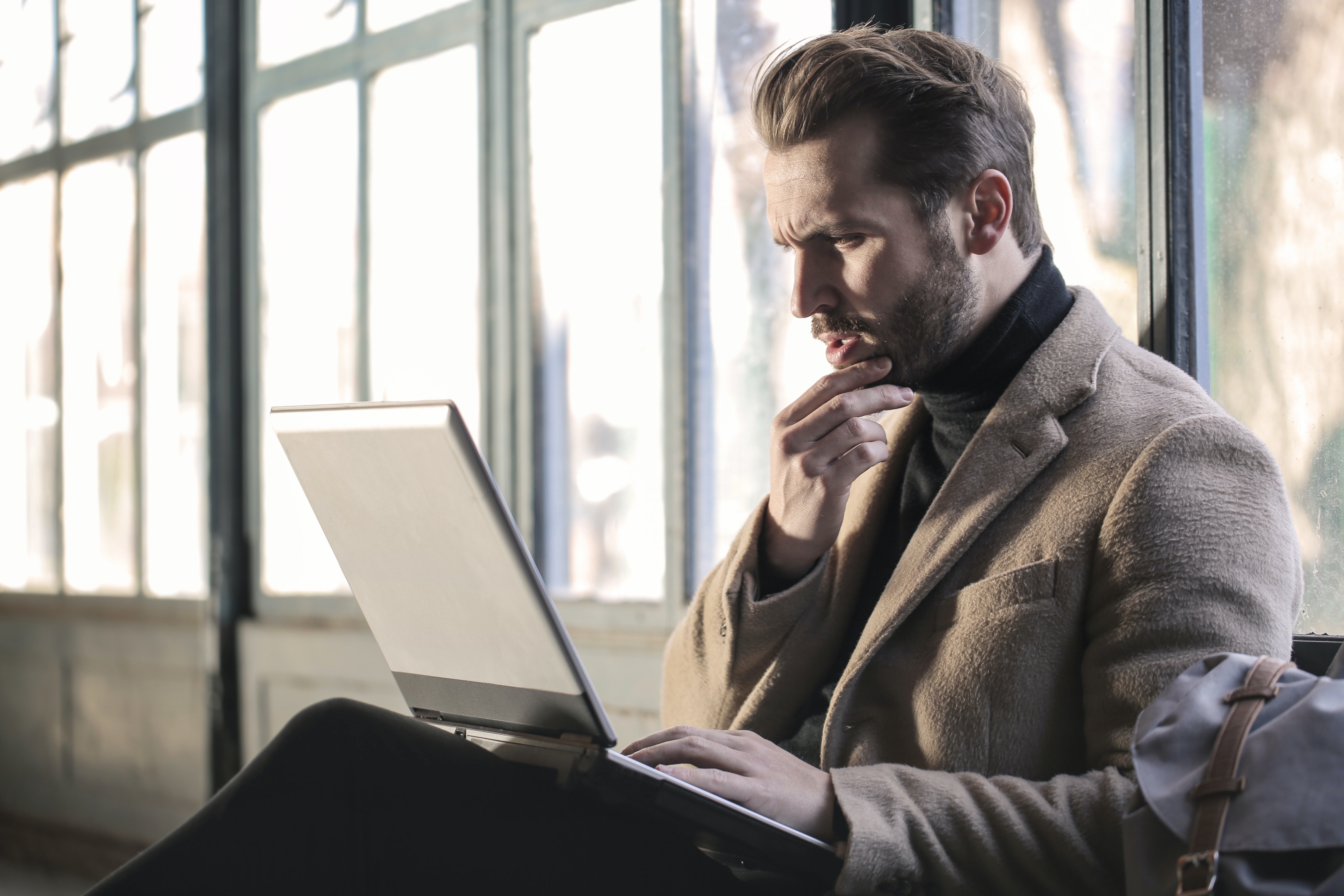 man looking at his laptop